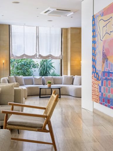Lobby lounge with a curved sofa and colourful artwork
